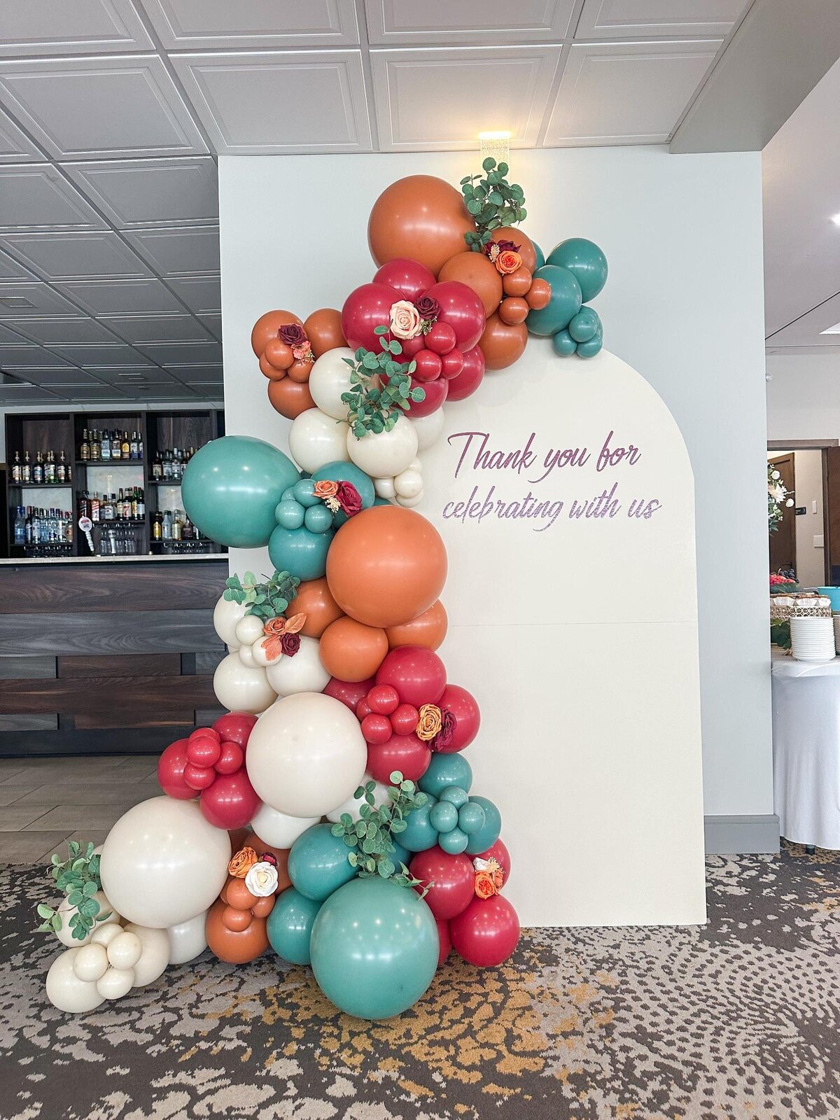 balloons and florals with backdrop
