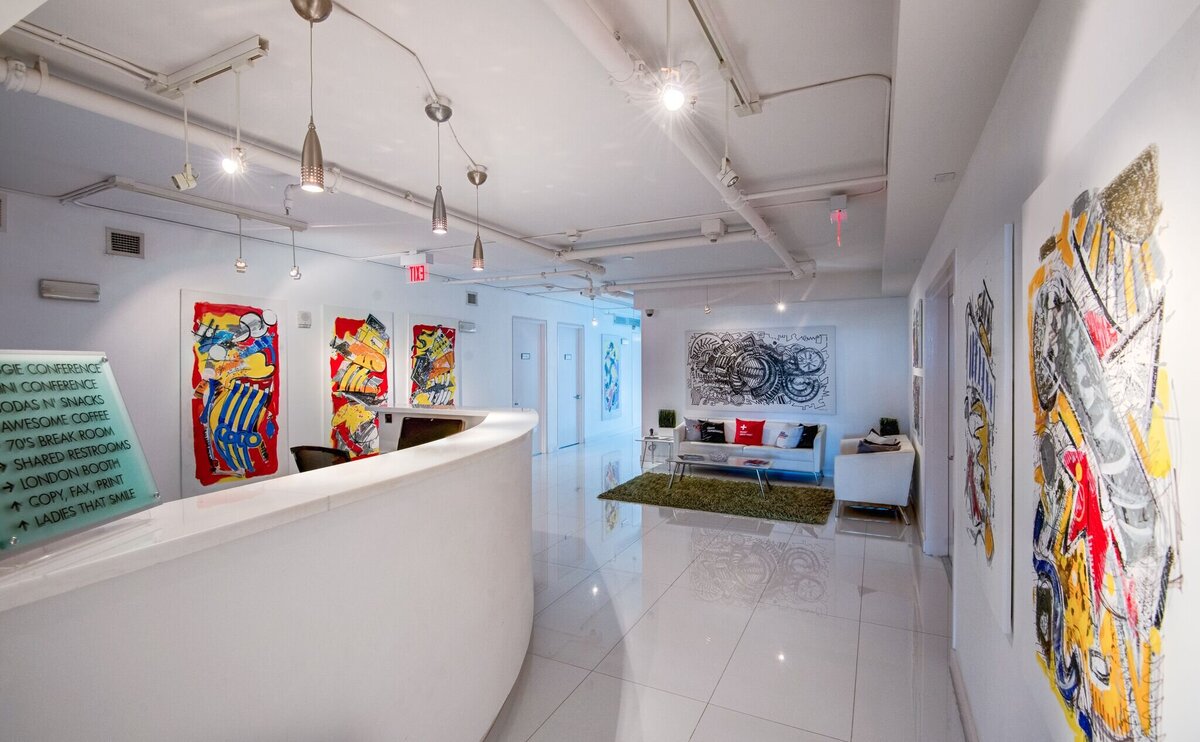 MiamiShared reception desk with a long hallway heading to the offices.