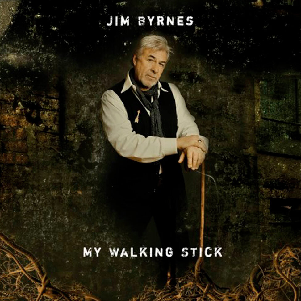 Album Cover Title My Walking Stick Artist Jim Bryne standing against old textured wood wall leaning on walking stick