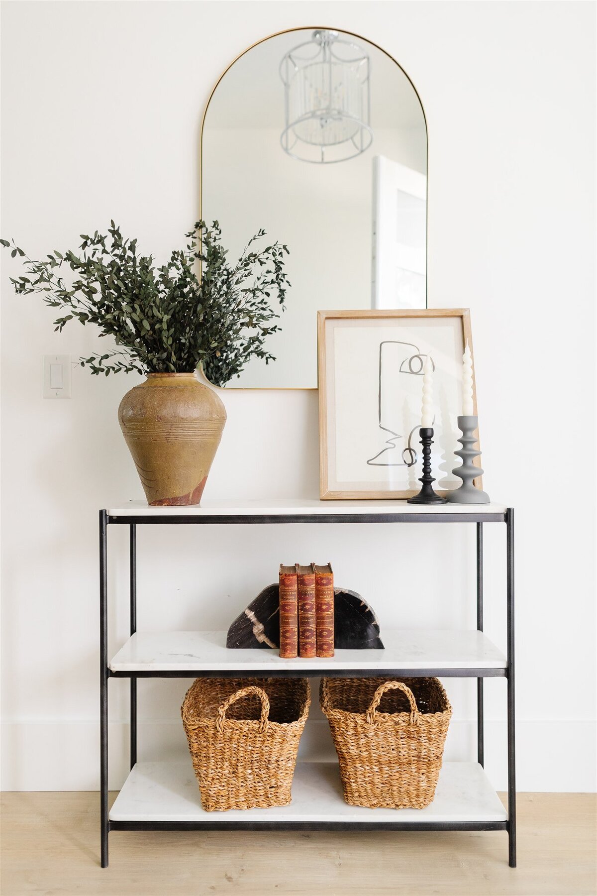 3 tier marble console table with plant bouquet and wooden frame