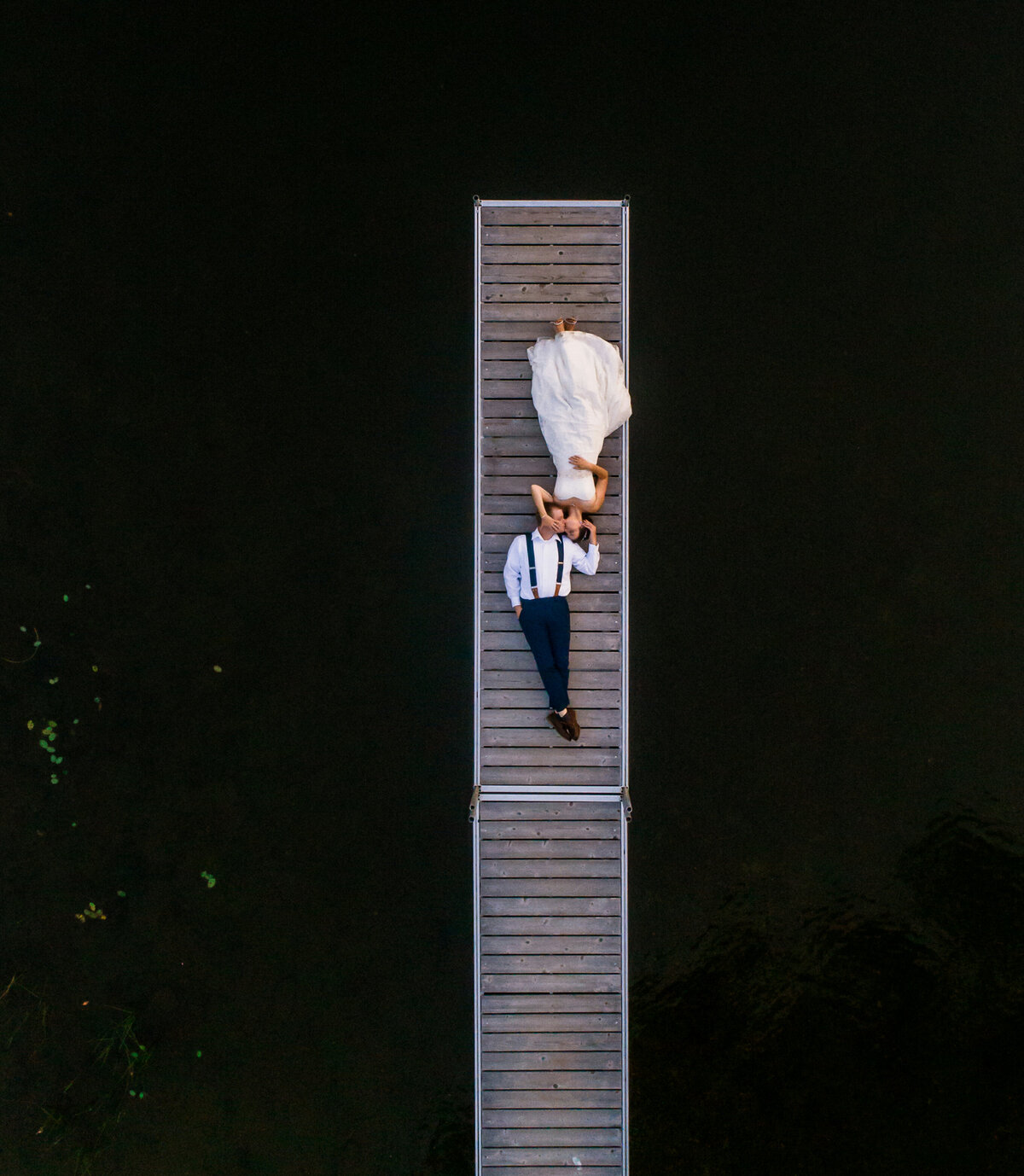 Bride and Groom lying on dock, aerial photography | Wedding Photography