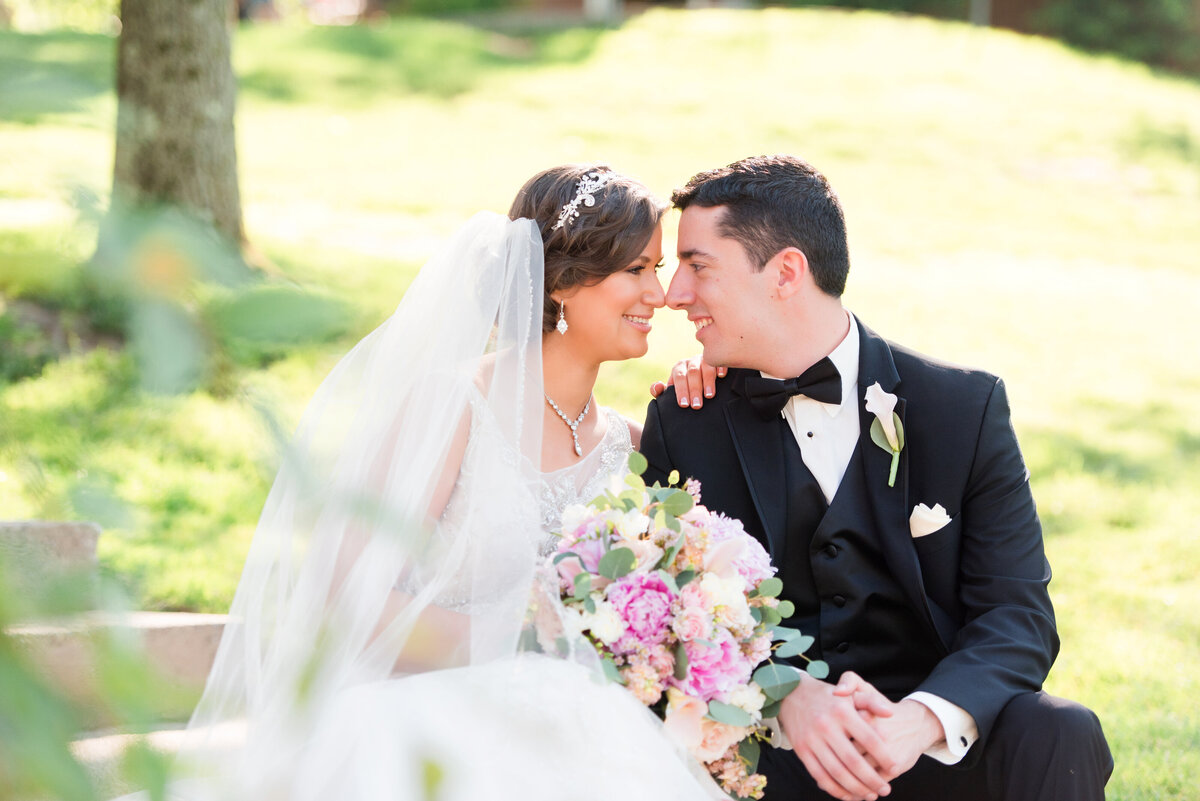bride and groom posing for wedding photo on a set of steps alongside the fox chapel golf club in pittsburgh