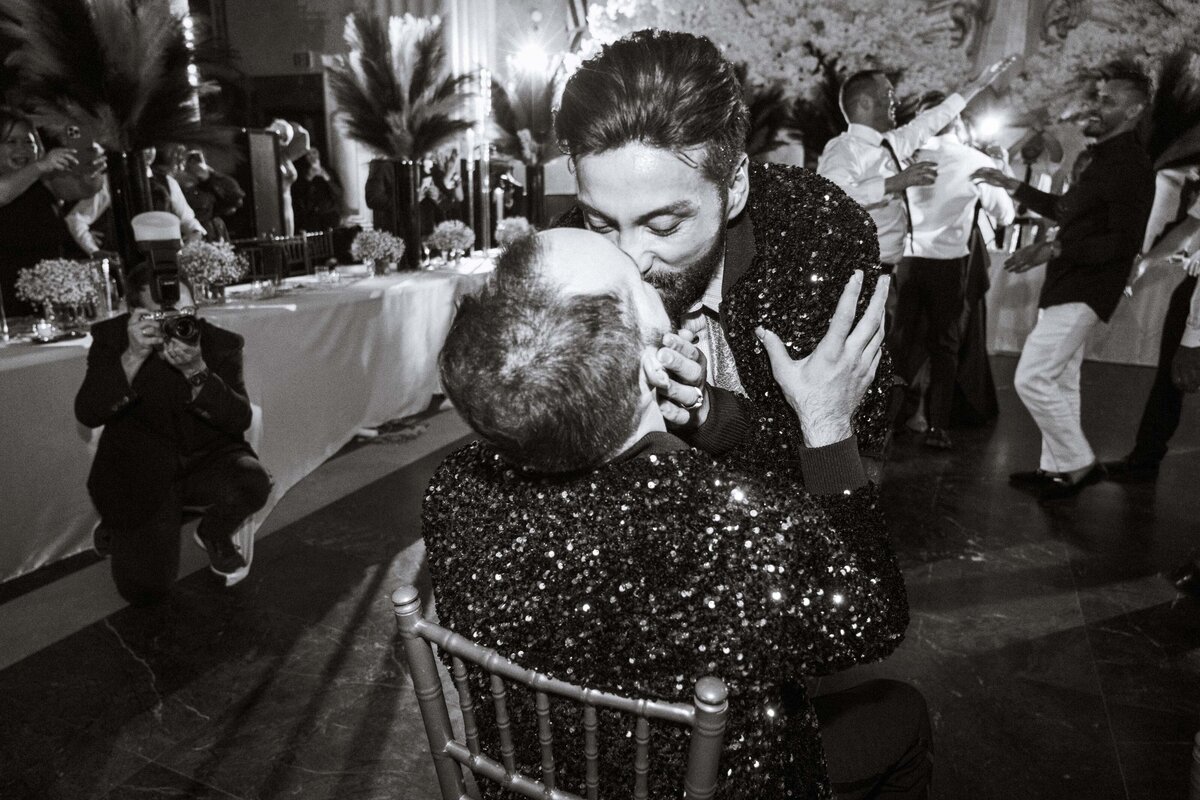 grooms-kissing-during-reception