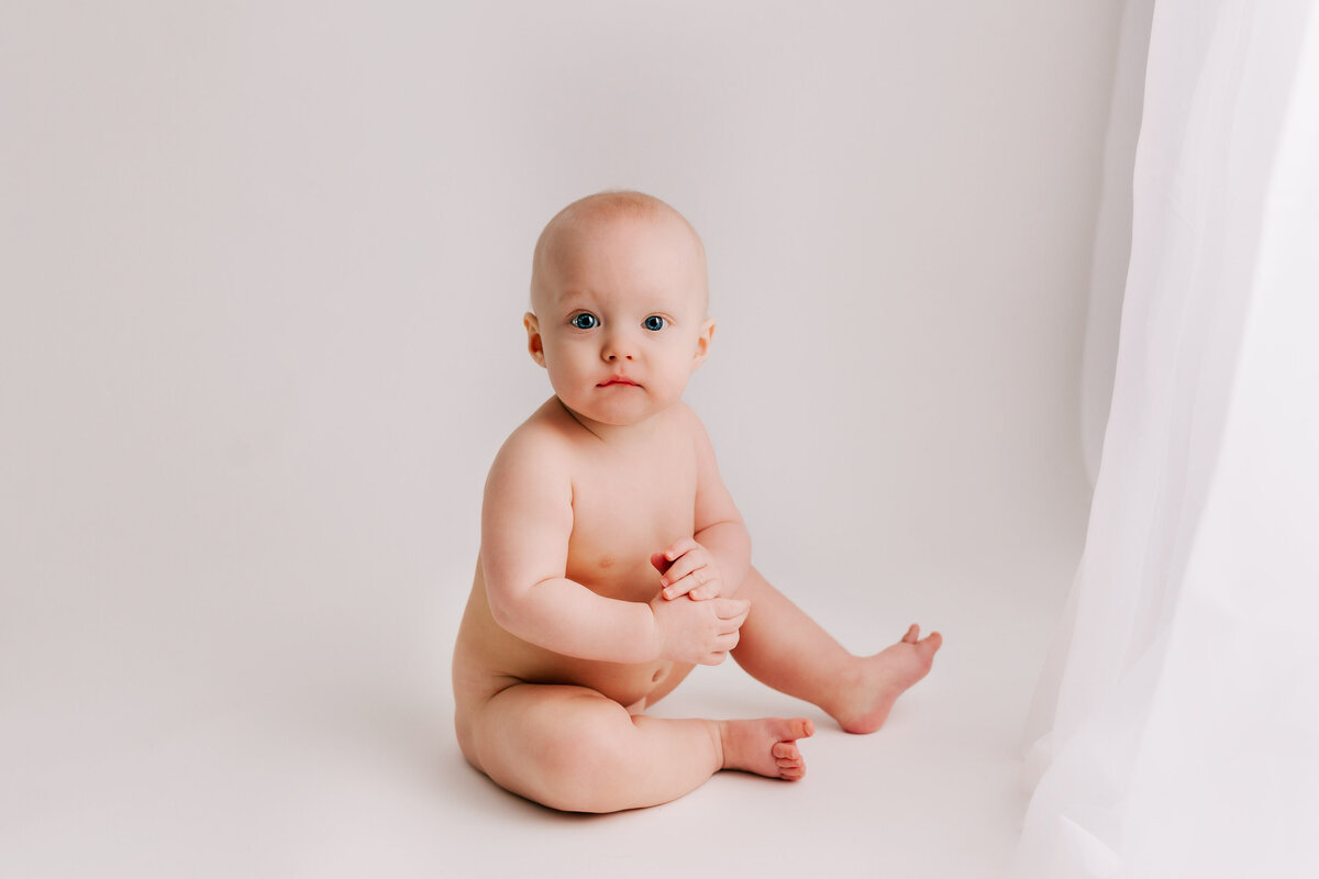 Little 7 month old baby sits for his little sitter session with cambridge milestone photographer