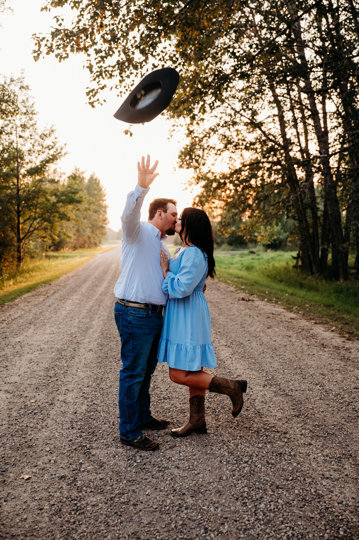 cowboy throws his hat to create stunning engagement photo