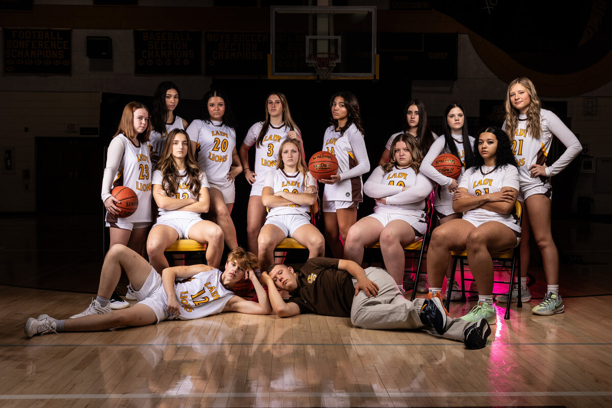 basketball team sitting together looking fierce for their dramatic sports photos in Greensburg.