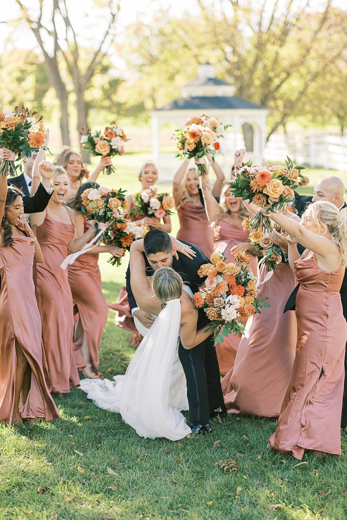 Dip kiss in front of bridal party