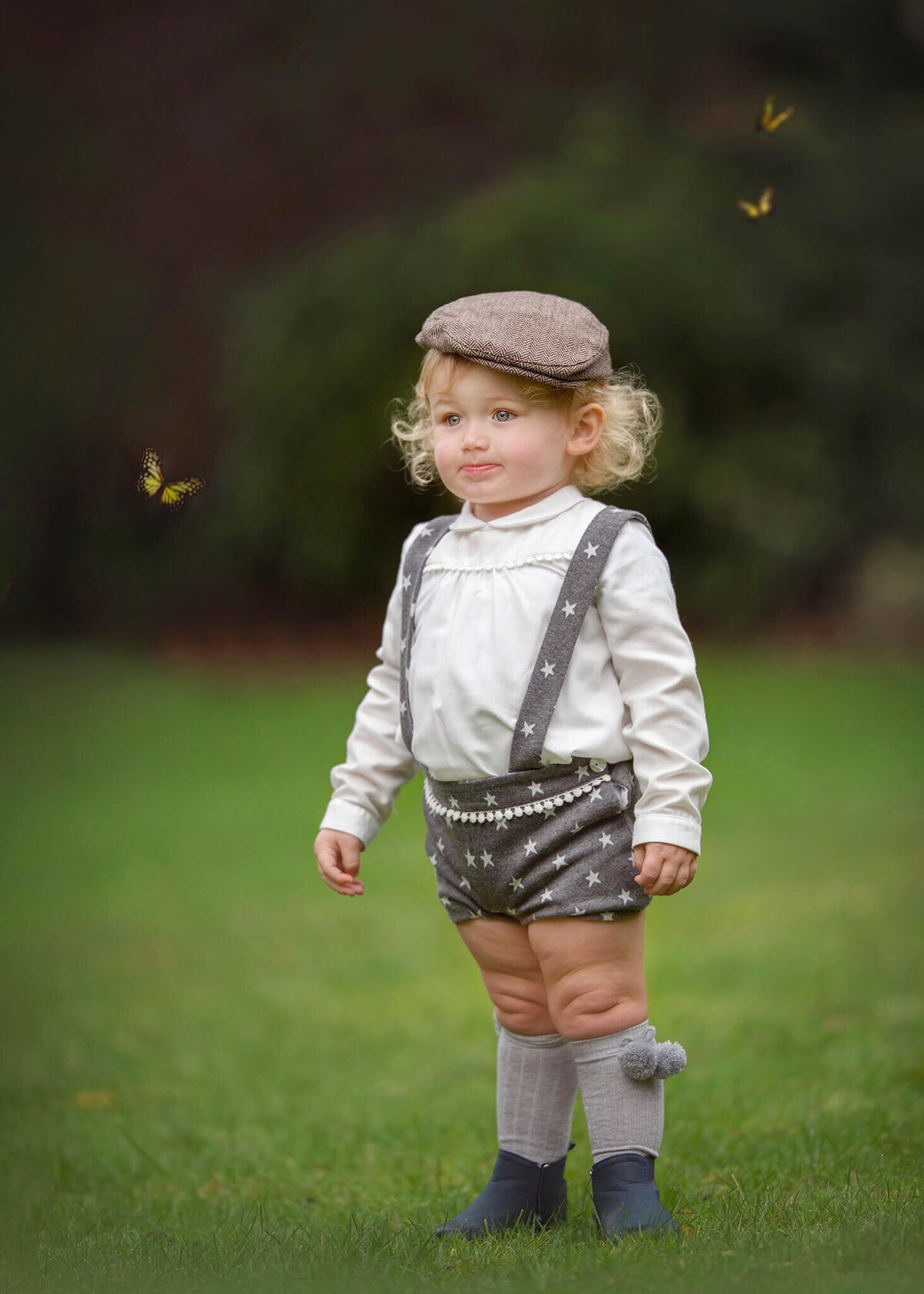 Little boy in a flat cap and overalls with butterflys at the park - Los Angeles Children’s Photographer