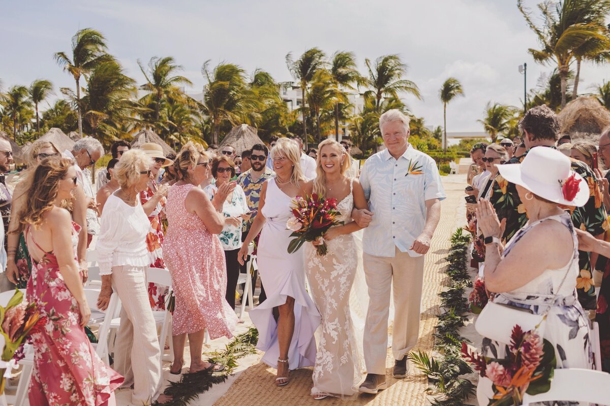 Bride walking down aisle at beach wedding in Cancun