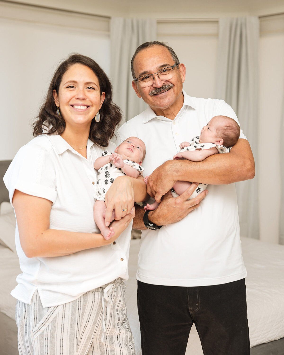Mother holding newborn during in-home lifestyle photo session in Central Florida

