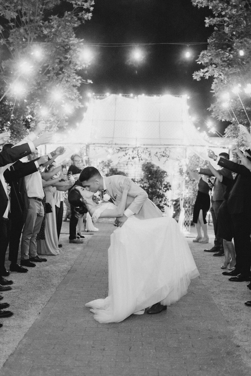 couple kissing during sparkler exit at terrain