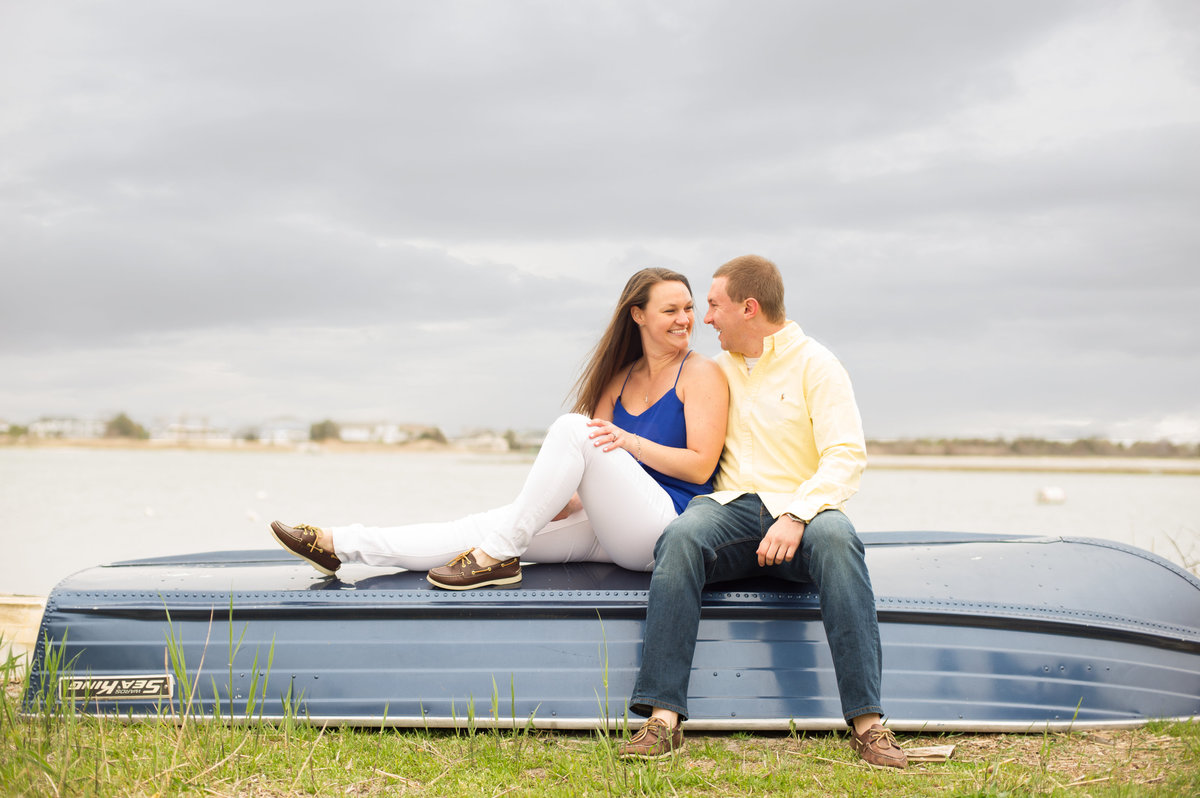 couple sitting on blue boat