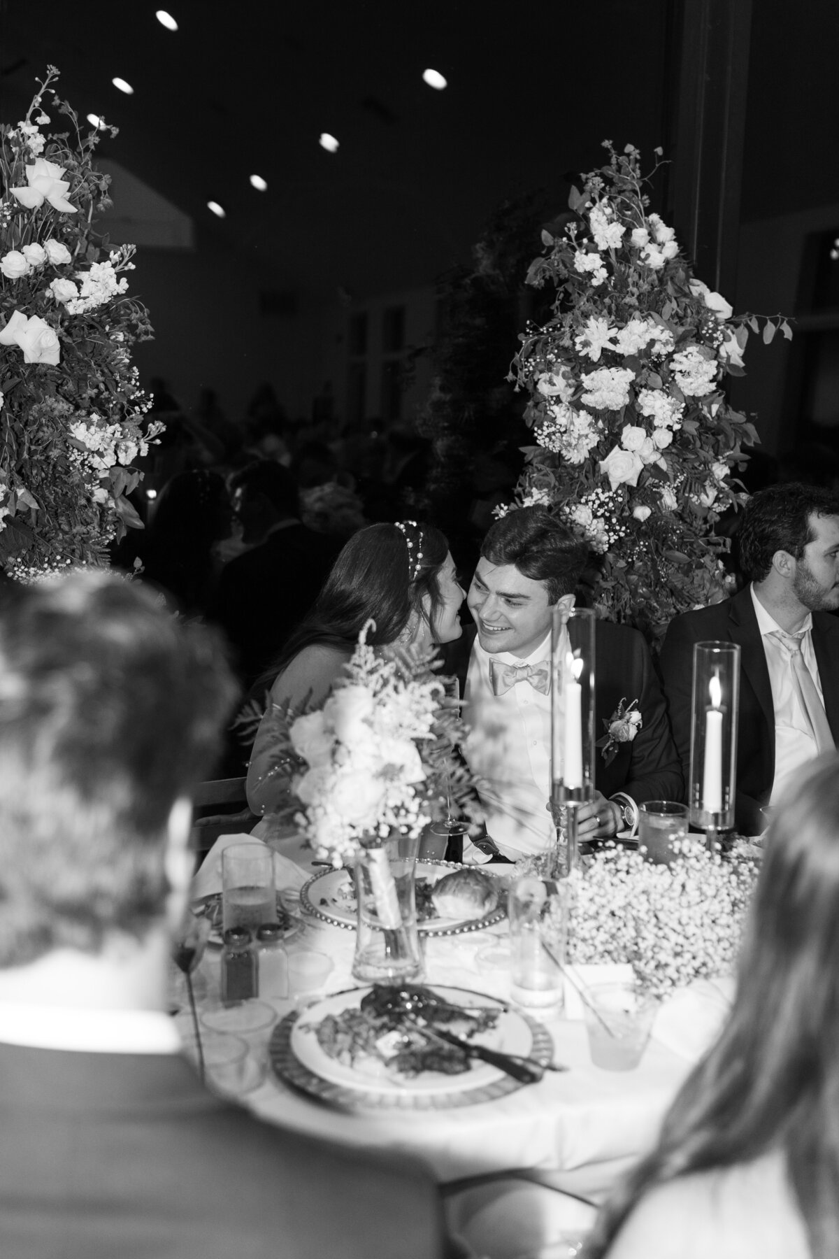 Candid shot of the couple sharing a quiet, intimate moment during their wedding reception.