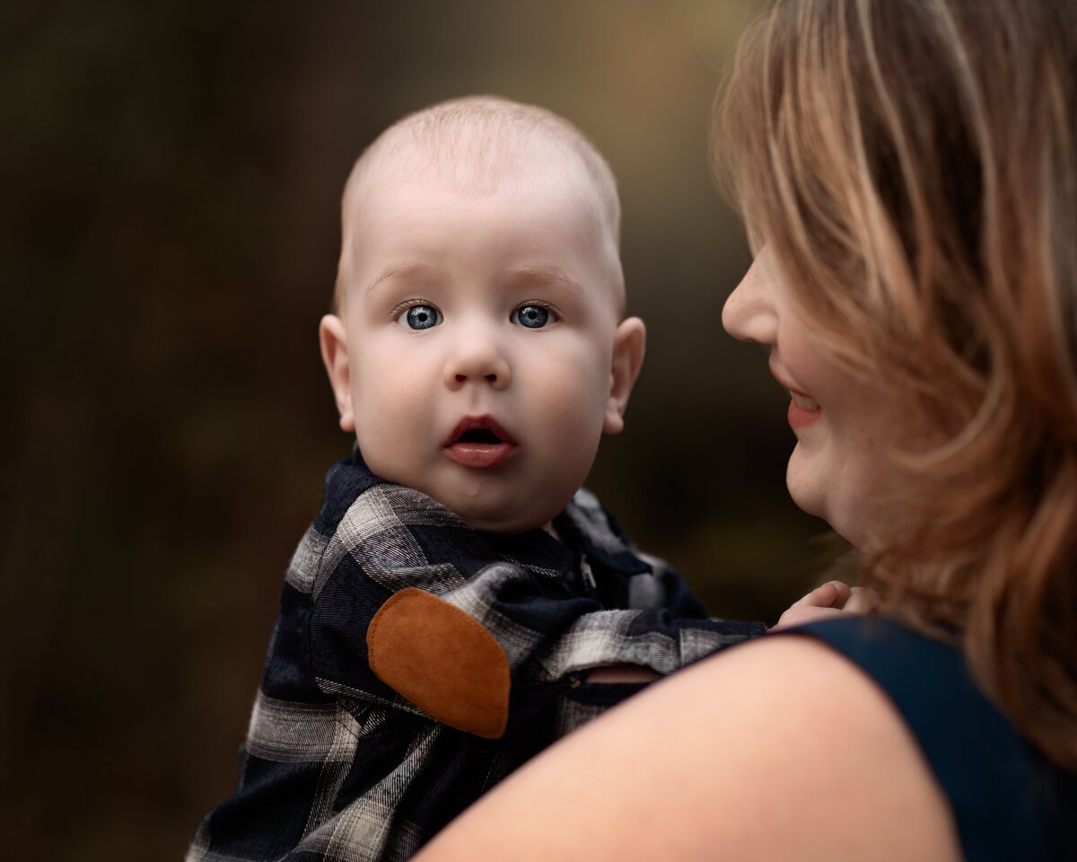 Outdoor milestone moment between mother and baby—captured in warm fall tones during a session in Ayr, Ontario.