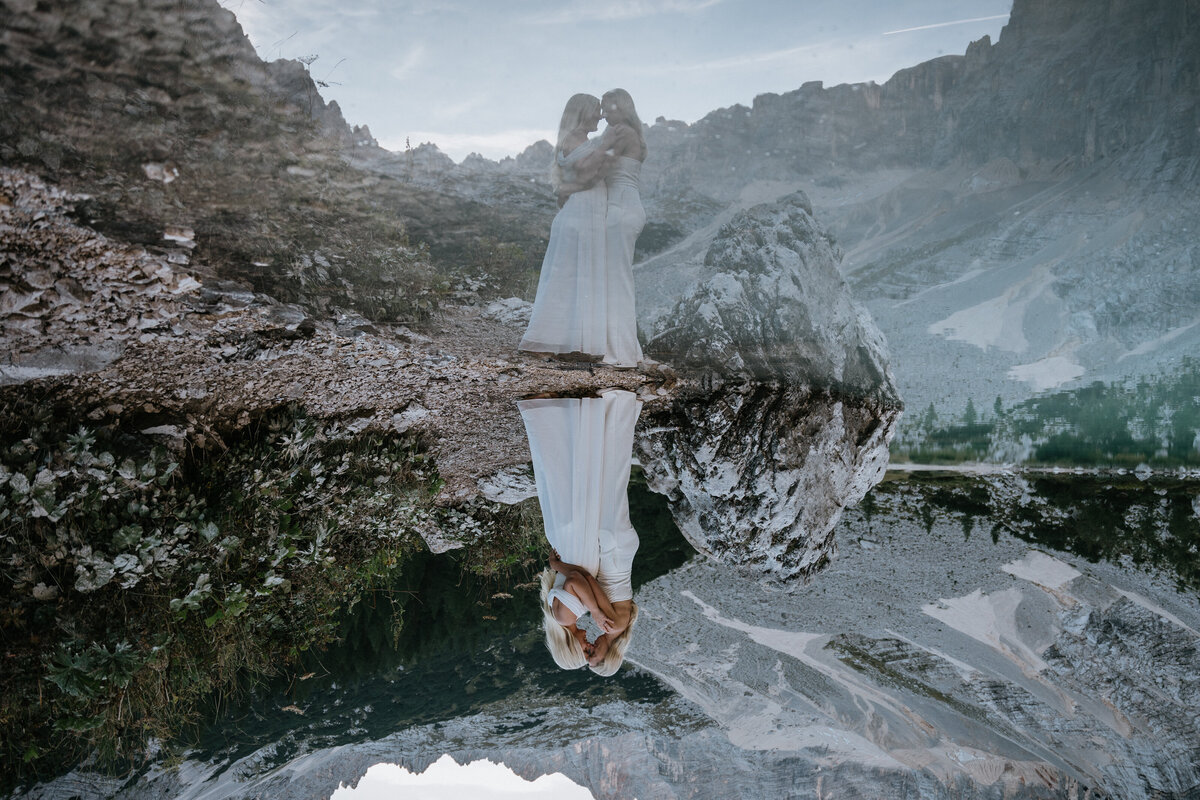 Lesbians eloping in the Italian Dolomites on Lago Sorapis with reflections