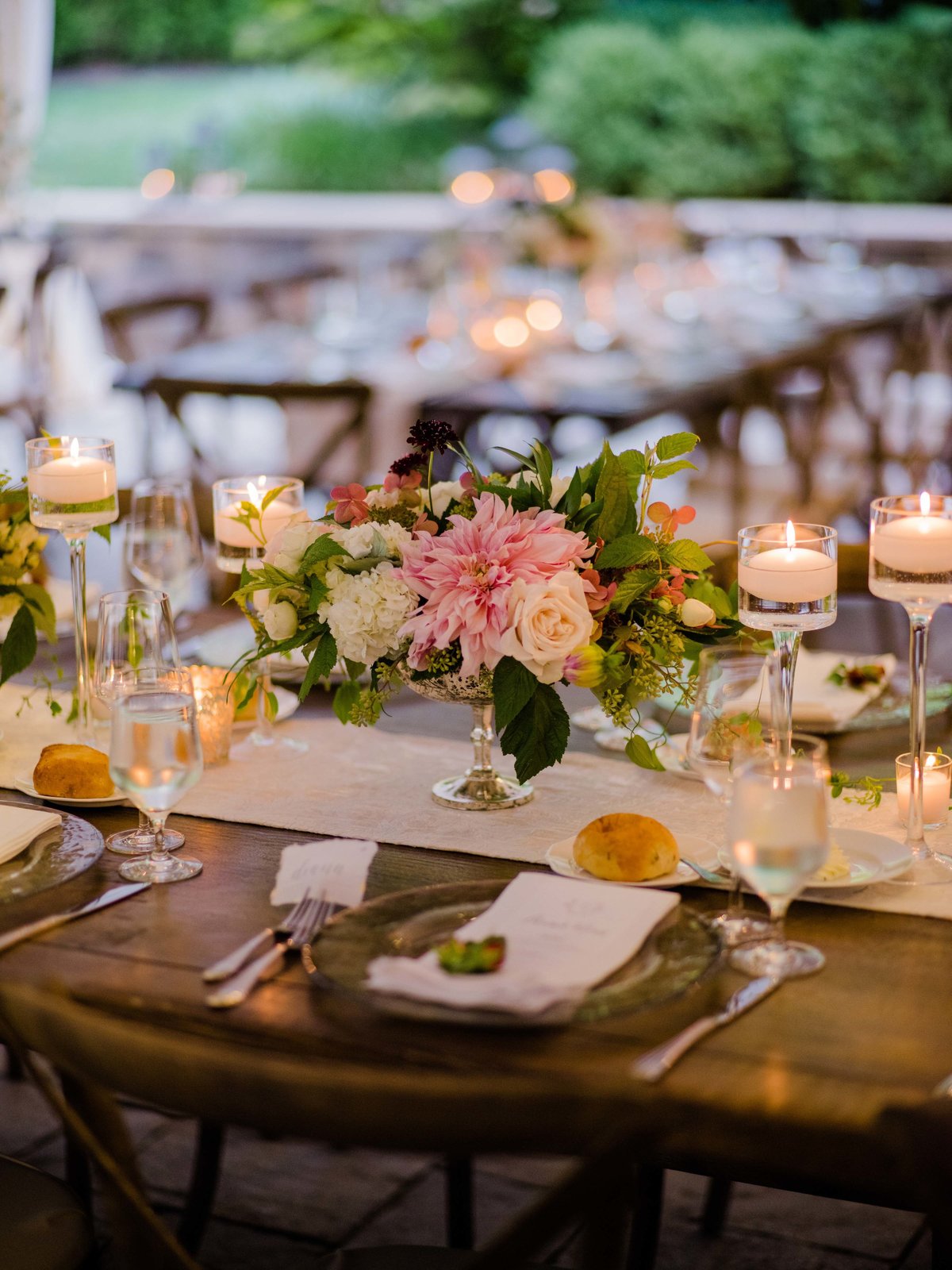 Low compote arrangement with blush dahlia and roses look stunning at this garden tent wedding.