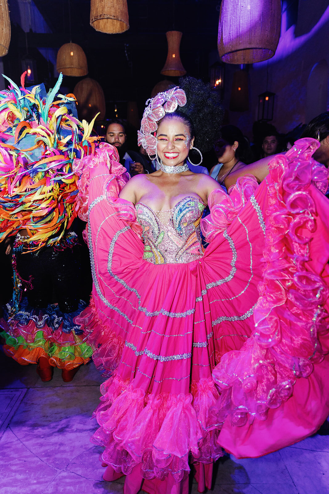 A stunning Colombian dancer in a bright pink folkloric dress, performing at Victoria and Daniel’s Cartagena wedding reception.