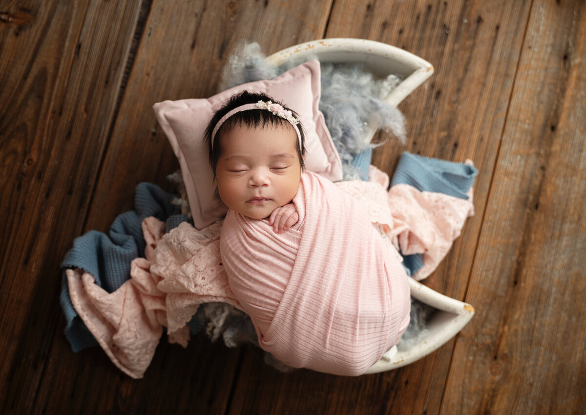aledo newborn girl in a moon prop