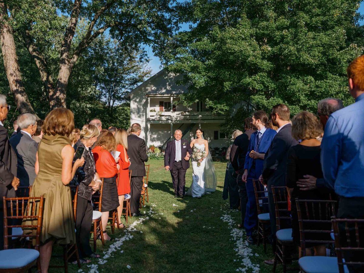 Outdoor wedding ceremony under clear blue sky.