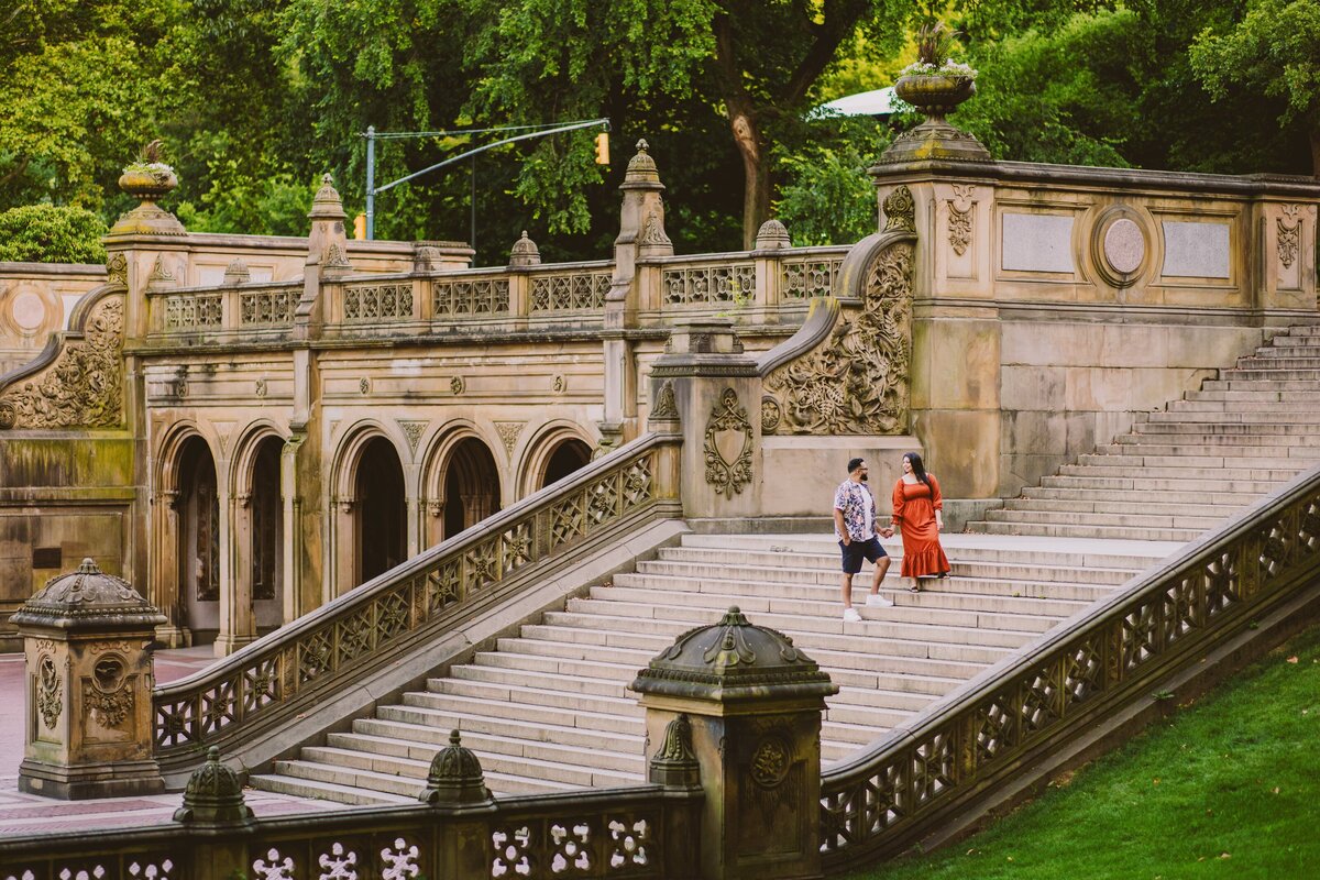 A wide shot of a couple on the stairs at central park bethesda terrace stairs