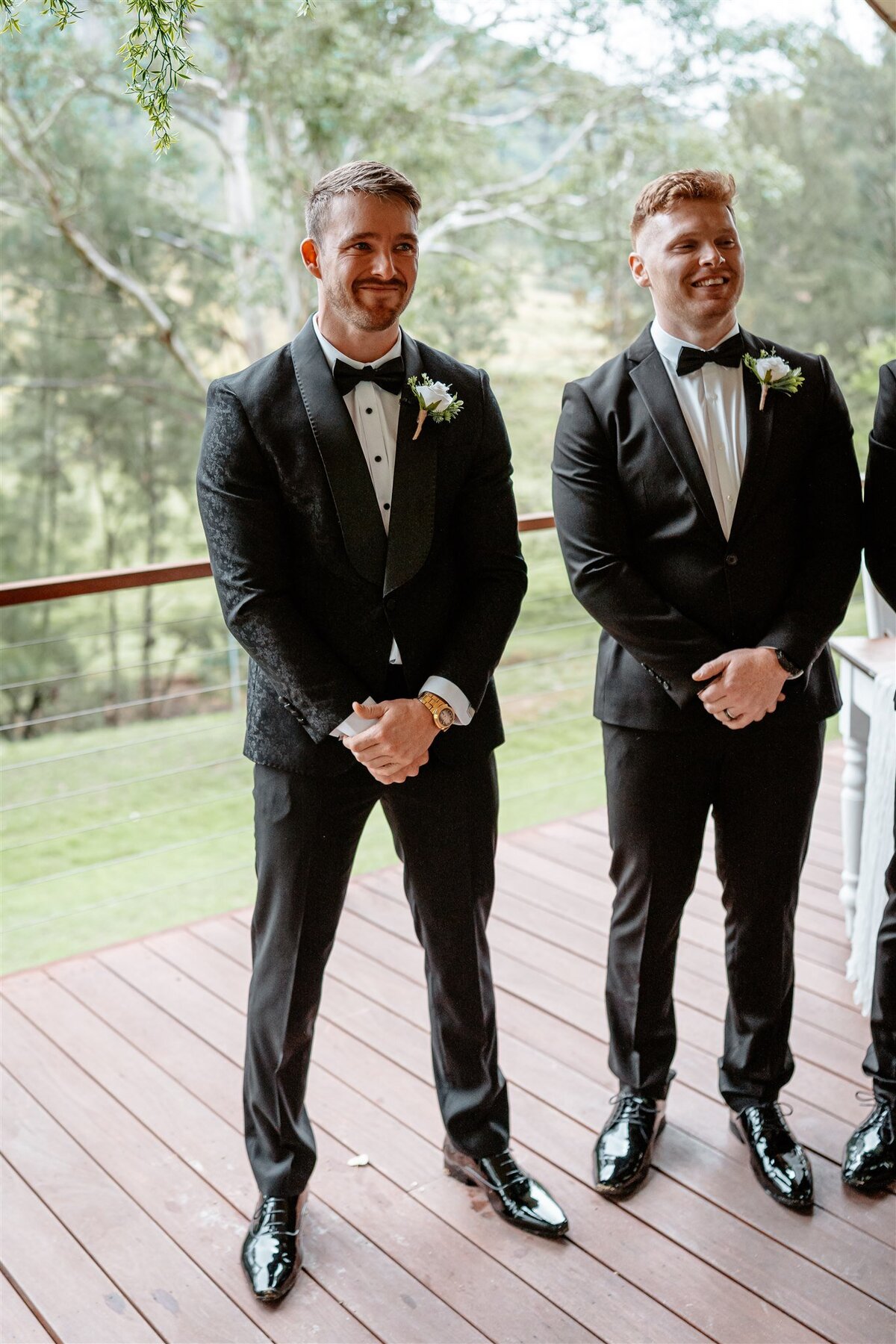 A groom, surrounded by his eager friends, awaits the arrival of his bride with joyful anticipation.