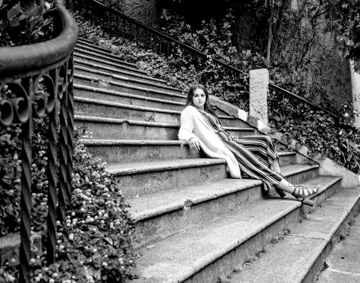 Girl sits on stairs in San Francisco senior portrait session