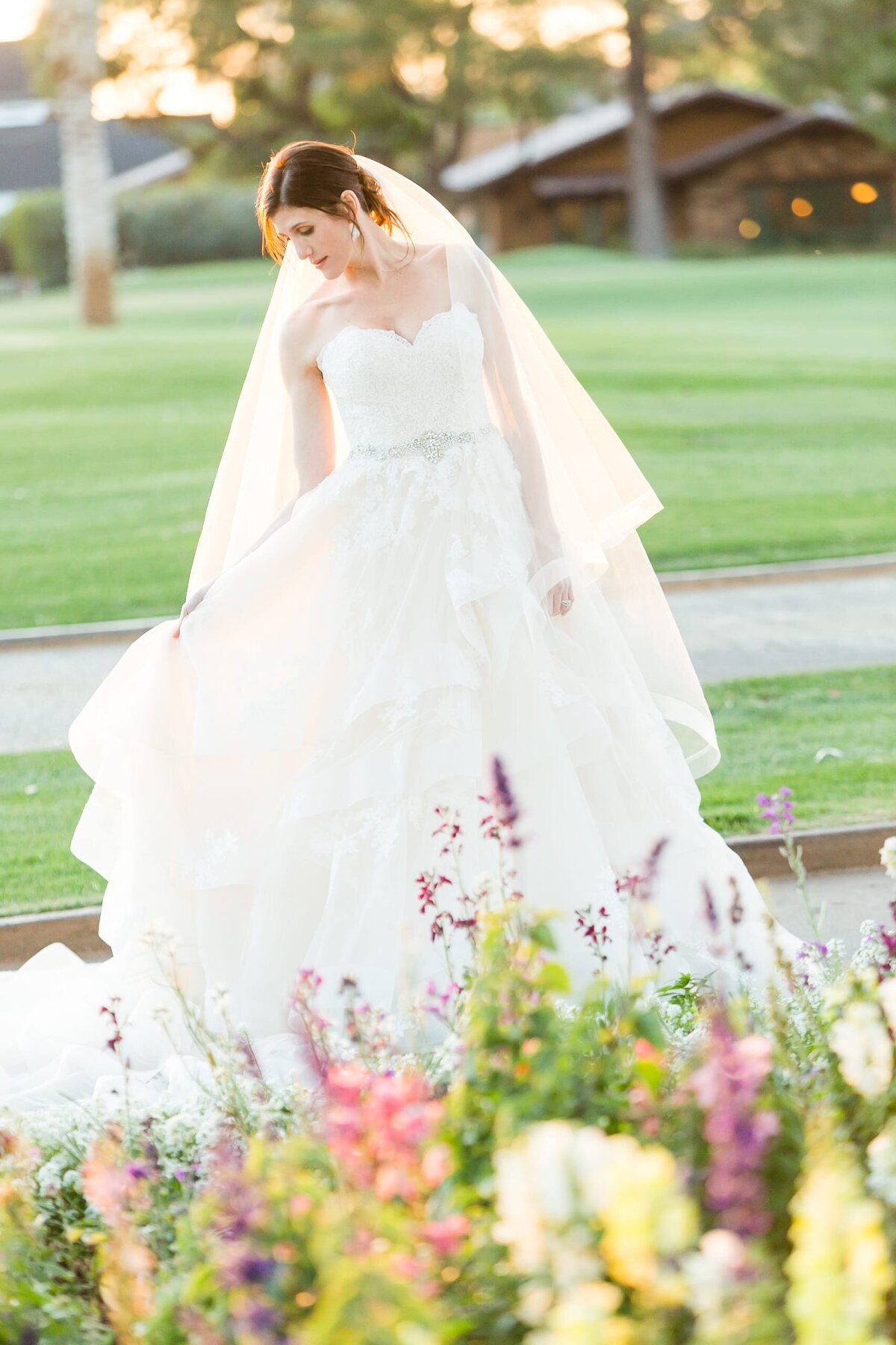 arizona coutry club bride by flower garden by scottsdale wedding photographer