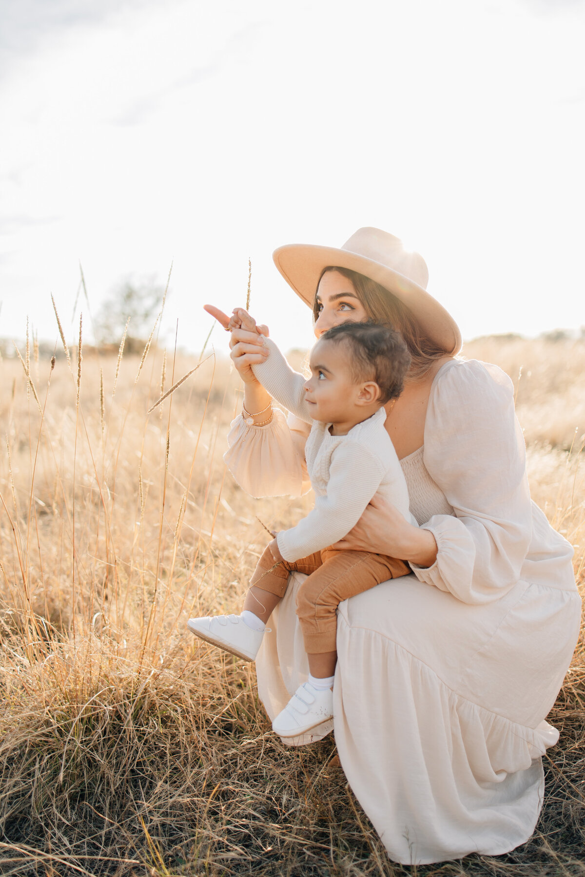 Motherhood golden hour family session . Taken in a golden fall field located in Flower Mound, TX