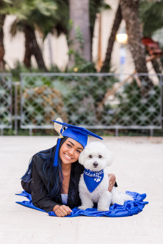 Senior girl in blue hat with dog
