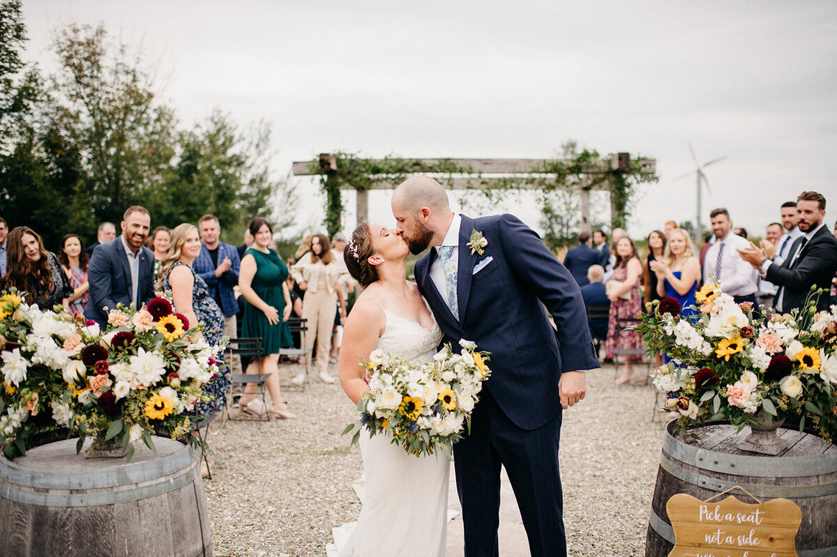 Bride and groom kissing during wedding ceremony, captured by Kristin Sarah Photography. Featured on the Bronte Bride Vendor Guide.