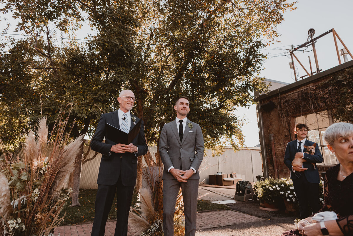 Groom waits with the officiant at the start of his wedding ceremony at Blanc Denver.