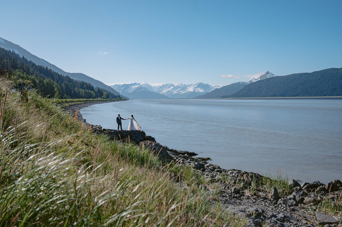 couple stand surround by the mountains