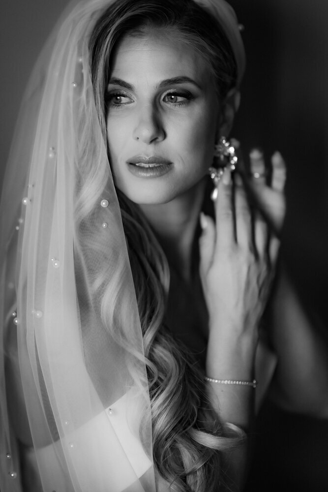 Bride Putting on Earrings