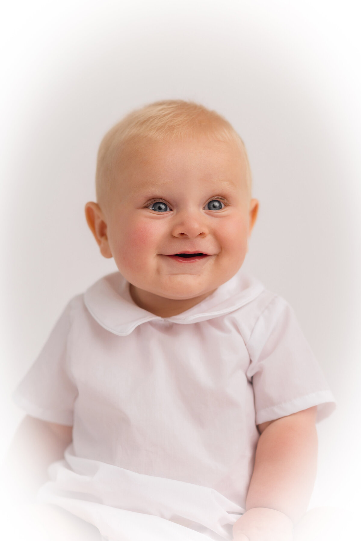 Baby smiles into the camera during Heirloom Portrait Session in Charleston.