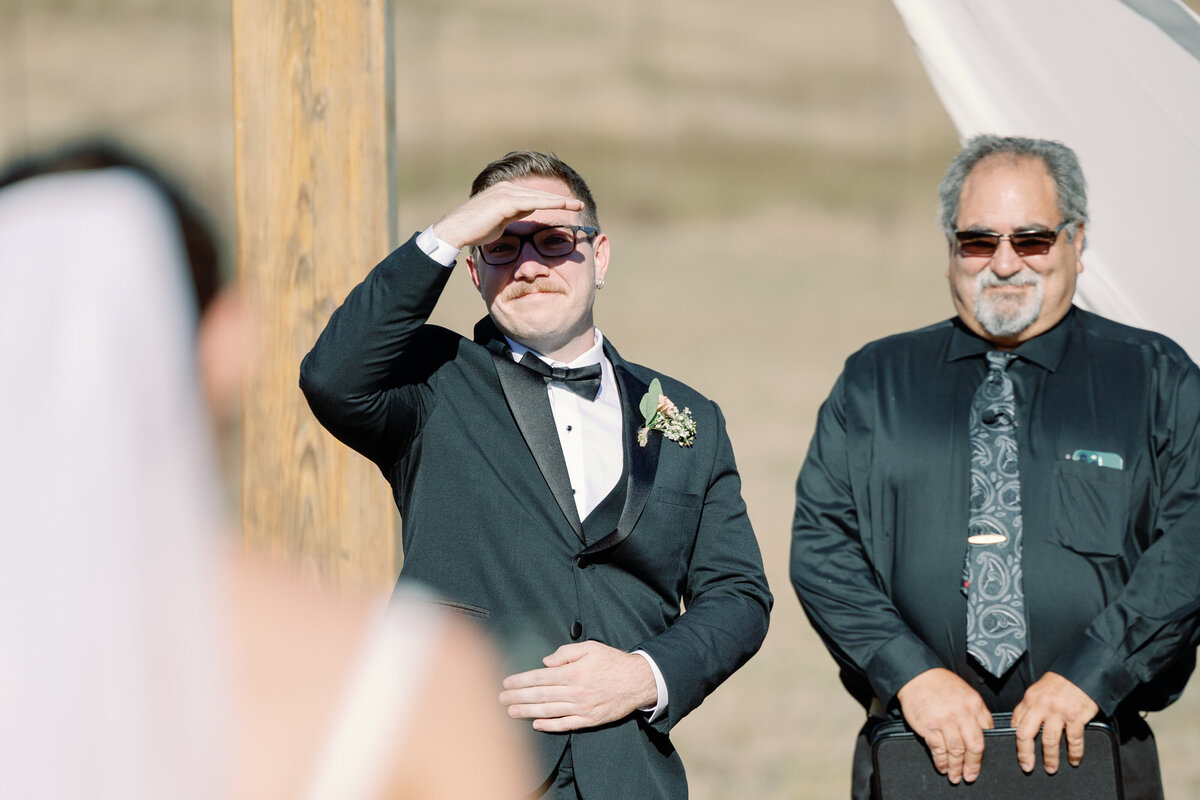 outdoor wedding ceremony with grom watching his bride walk down the aisle captured by wedding photographer bay area