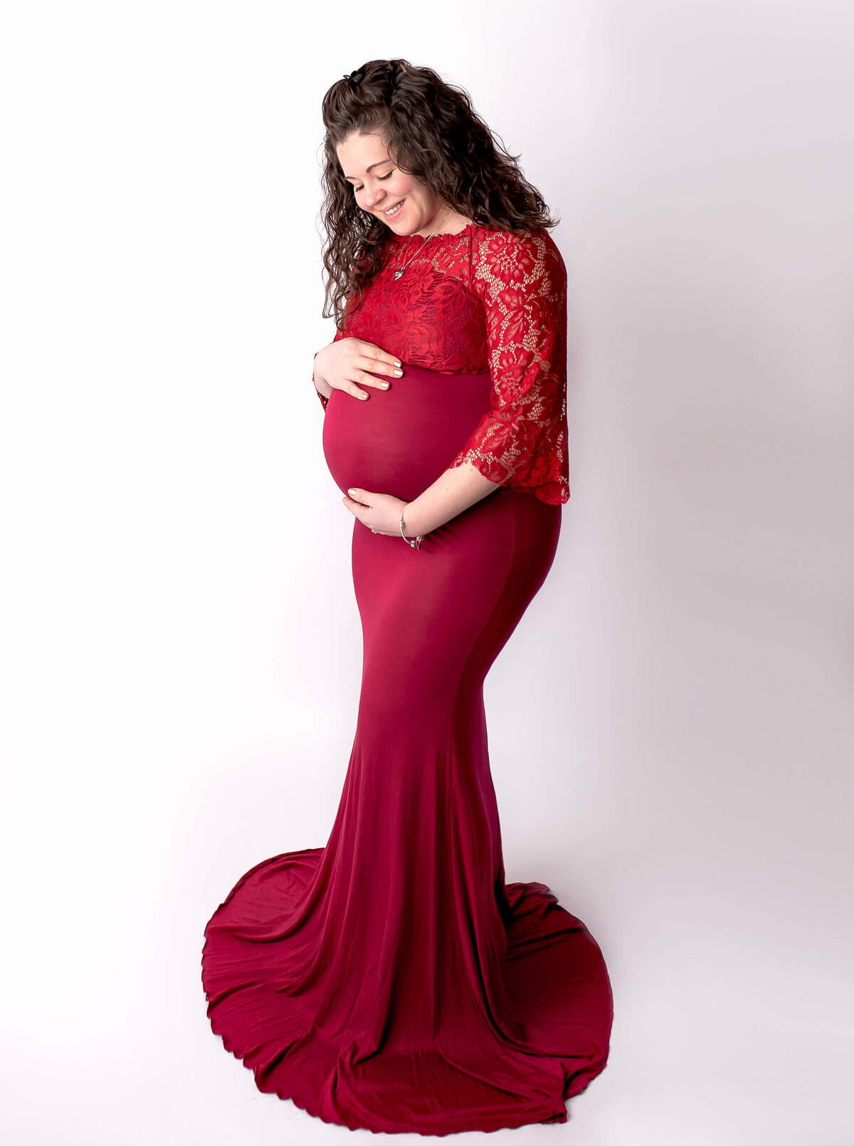 Akron maternity red dress in studio maternity.
