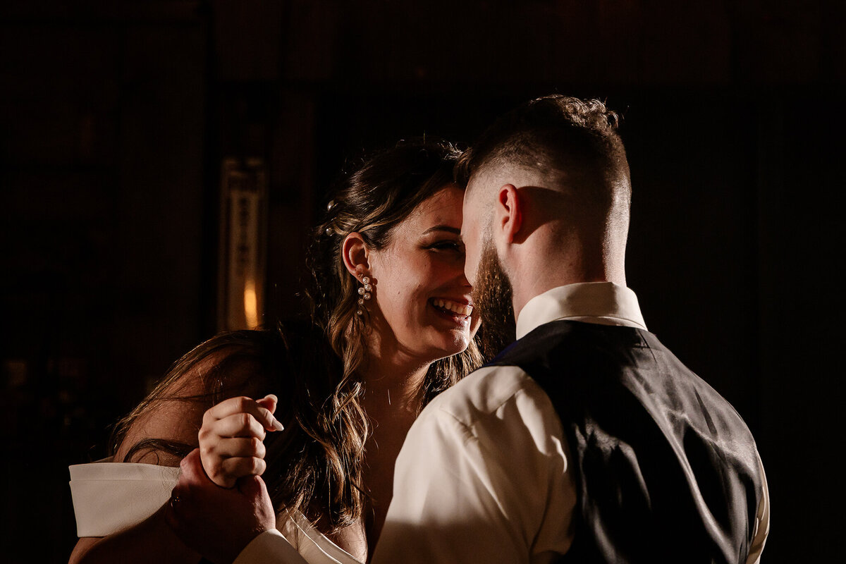 Bride and groom locking eyes during first dance at reception.