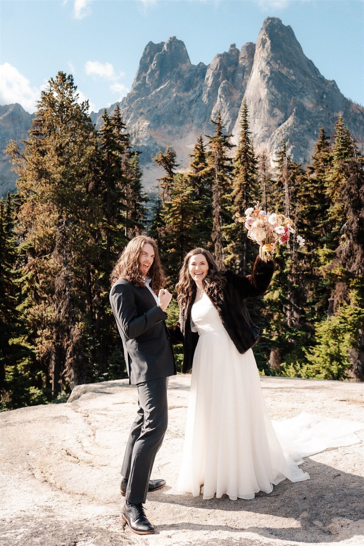 Bride & groom celebrating after their elopement at Washington Pass Overlook in North Cascades National Park!