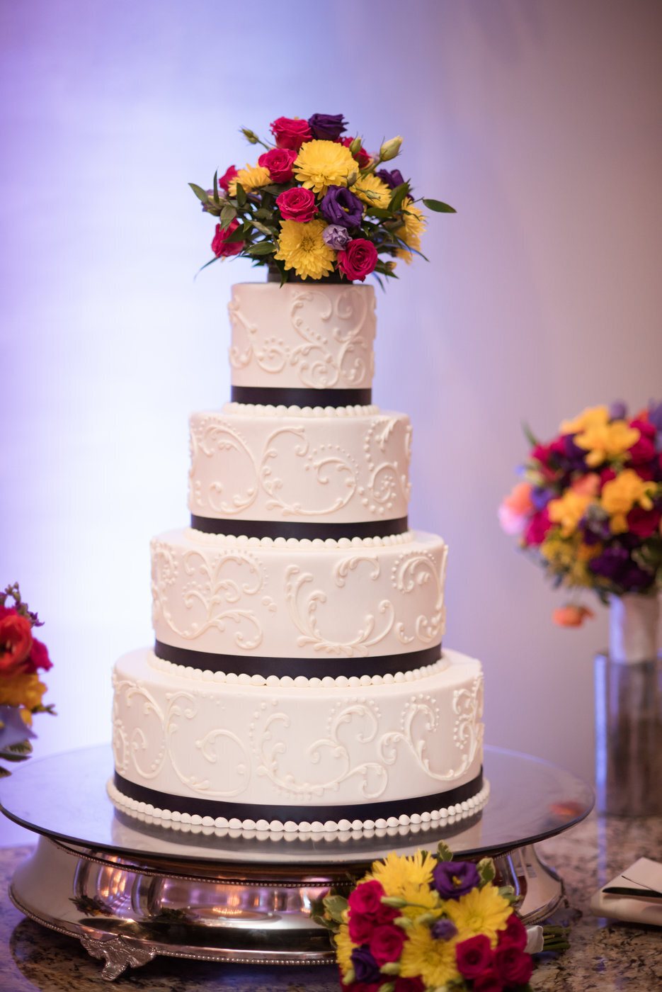 Wedding cake with floral top at Orlando wedding reception