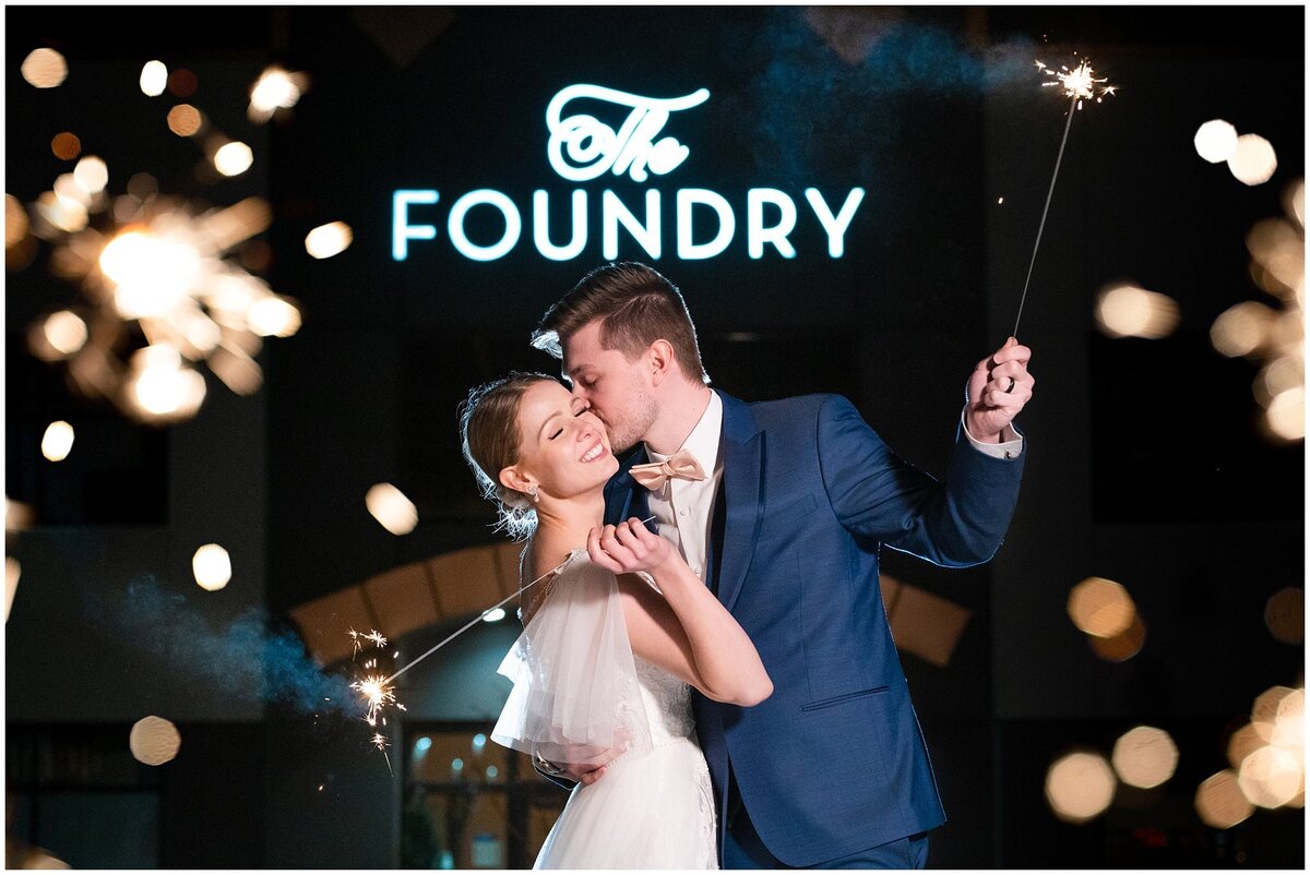 Bride and Groom at night with sparklers in front of The Foundry