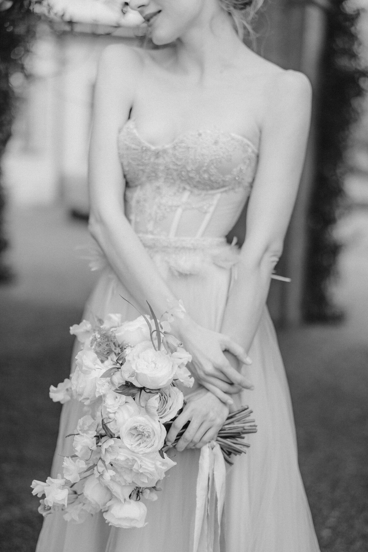 smiling-bride-beautiful-dress-with-bare-shoulders-holding-bouquet-pink-flowers