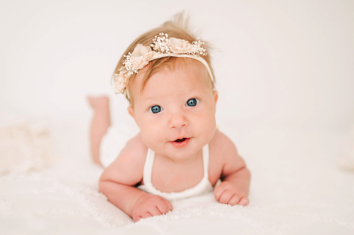 Branson Mo baby photographer Jessica Kennedy  of The XO Photography captures baby girl laying on belly during milestone session