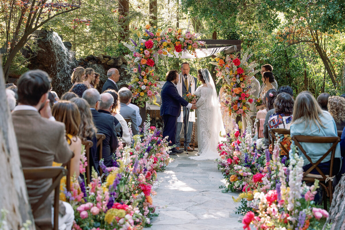 A bride and groom standing up saying their vows