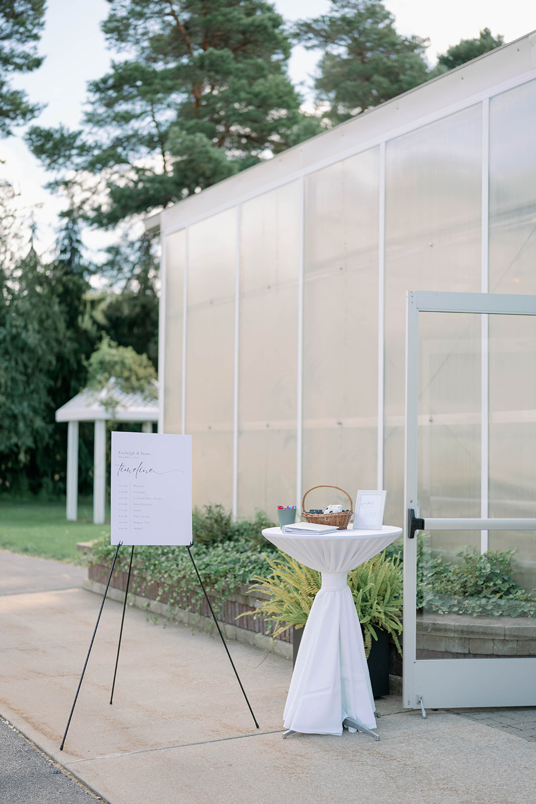The wedding welcome sign displayed in front of the Ivy House greenhouse in Saugatuck, Michigan.