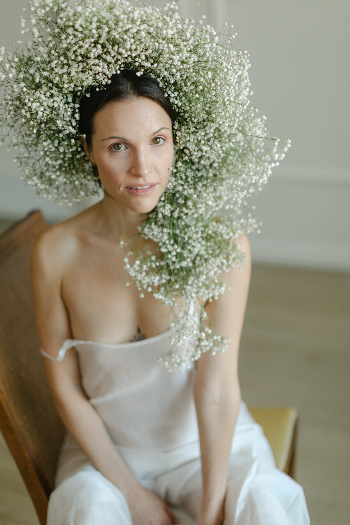 woman in white lingerie with green, floral headpiece