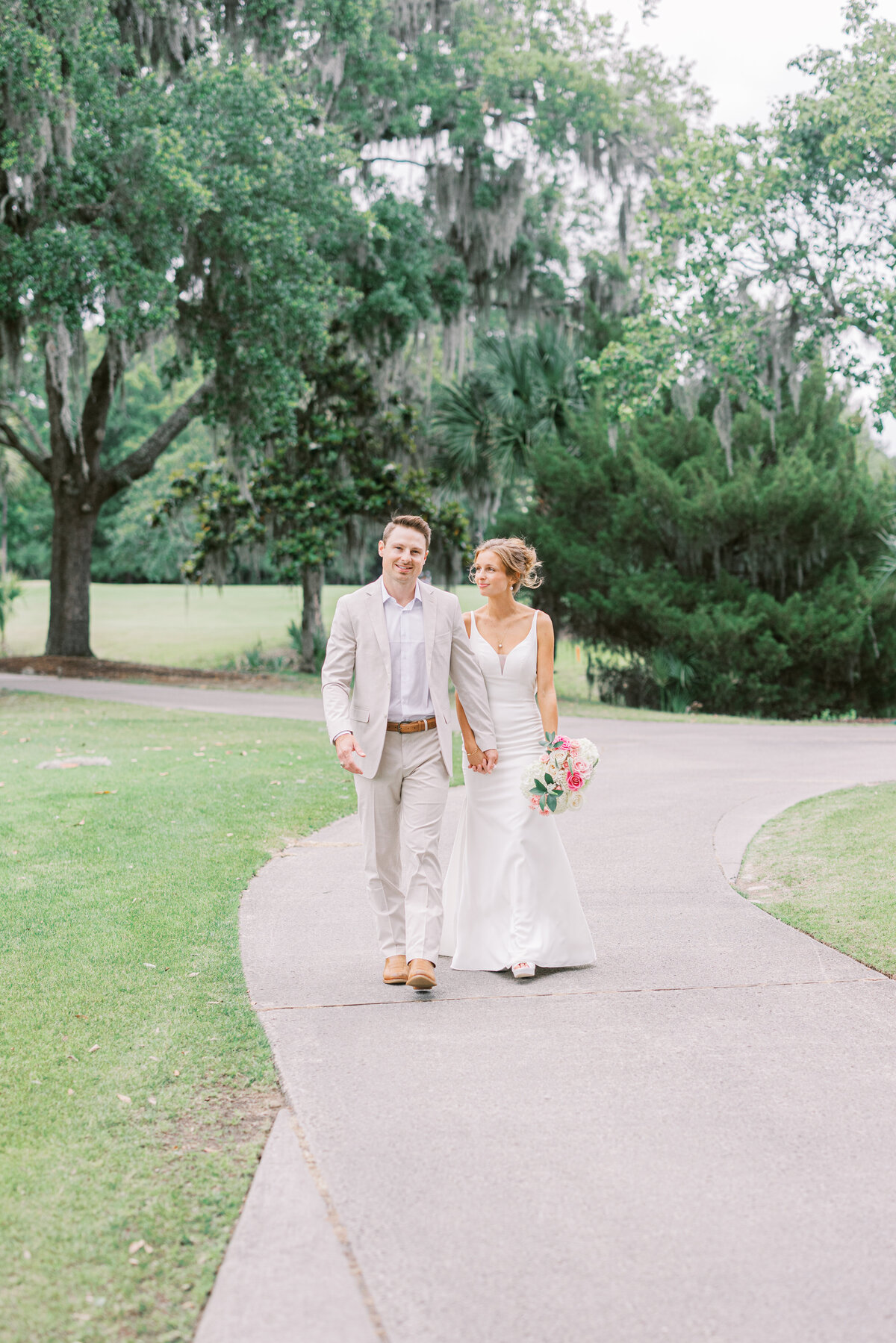 bride and groom walking during their couples photos for their Charleston wedding
