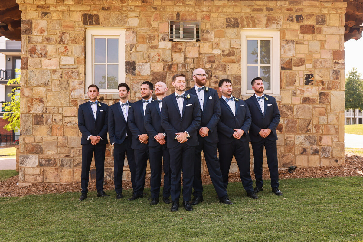 groomsmen looking off in the distance in front of marble building by Atlanta wedding photographer Amanda Richardson Photography
