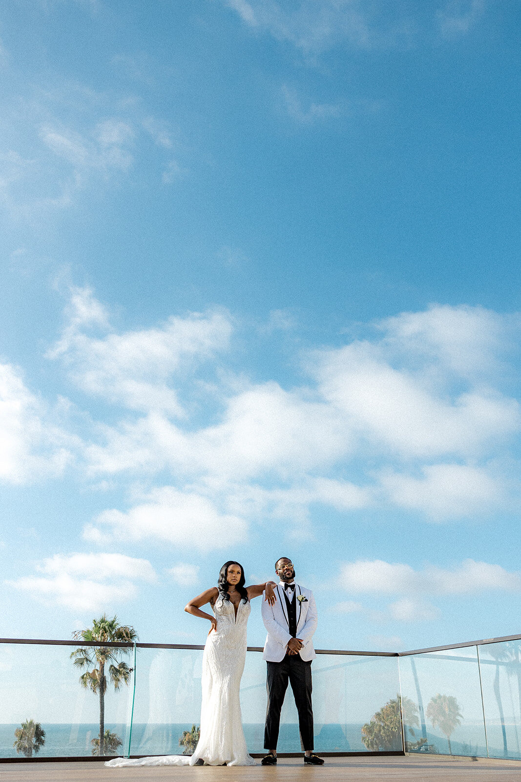 Bride and groom in bottom third of the image with the sky filling up the rest in San Diego