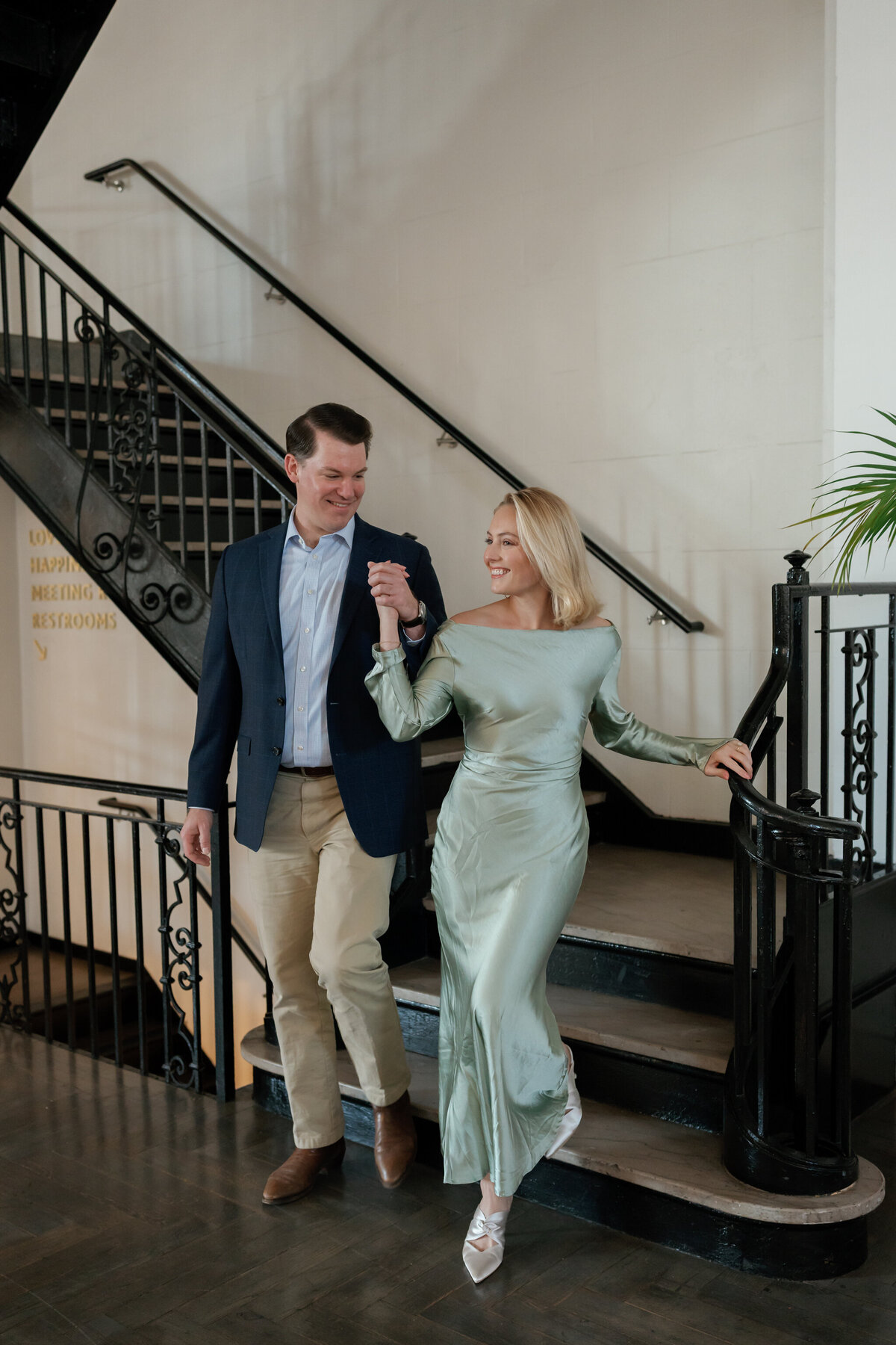 Quirk Hotel RVA Engagement Session in Richmond, VA | Engagement and Wedding Photographer in Richmond | couple walking down the stairs at the Quirk Hotel in Richmond