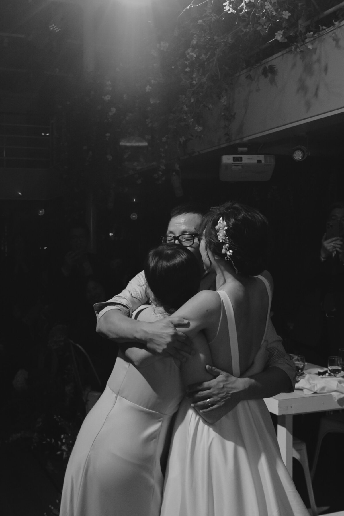 the bride hugging her father and sister